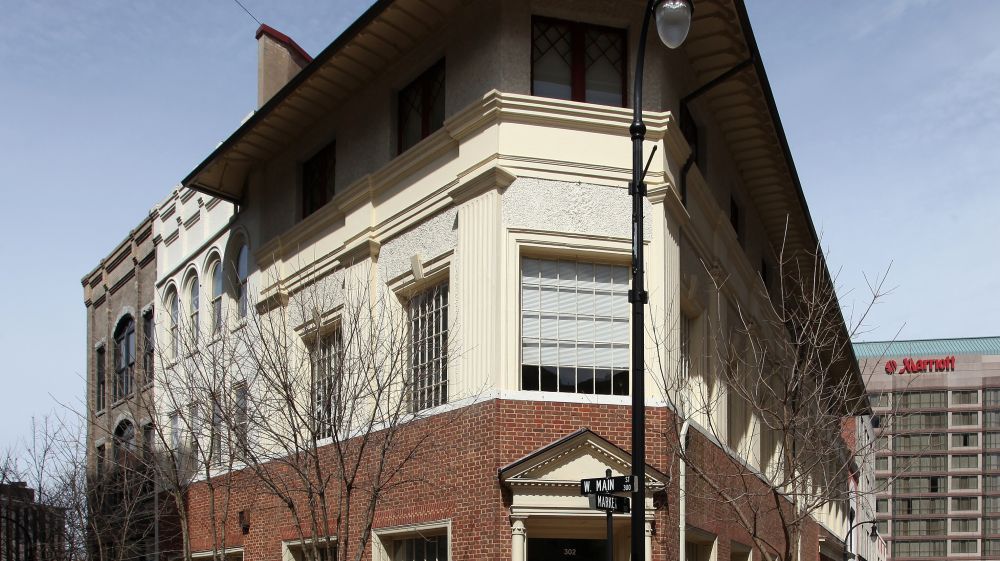 The Temple Building stands in red brick and off-white stone in Durham, NC.