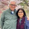Blogger David Jarmul poses with his wife for a photo in front of cherry blossoms.